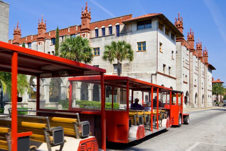 A tram drives past the Lightner Museum in St. Augustine