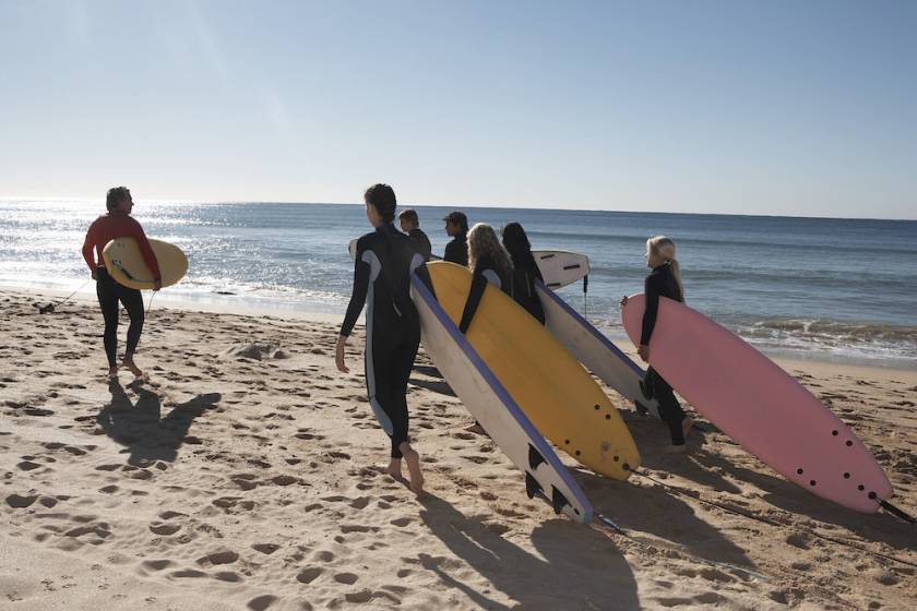 Group of people on beach for surf lessons
